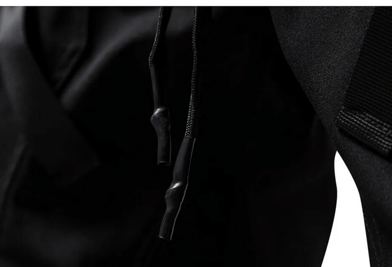 Close-up of stylish black joggers showcasing adjustable drawstrings, perfect for fashion-forward men.