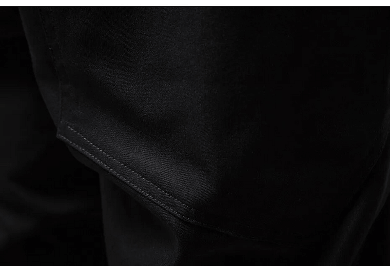 Close-up of black cotton cargo pants showcasing durable stitching and elastic waist design for added comfort.