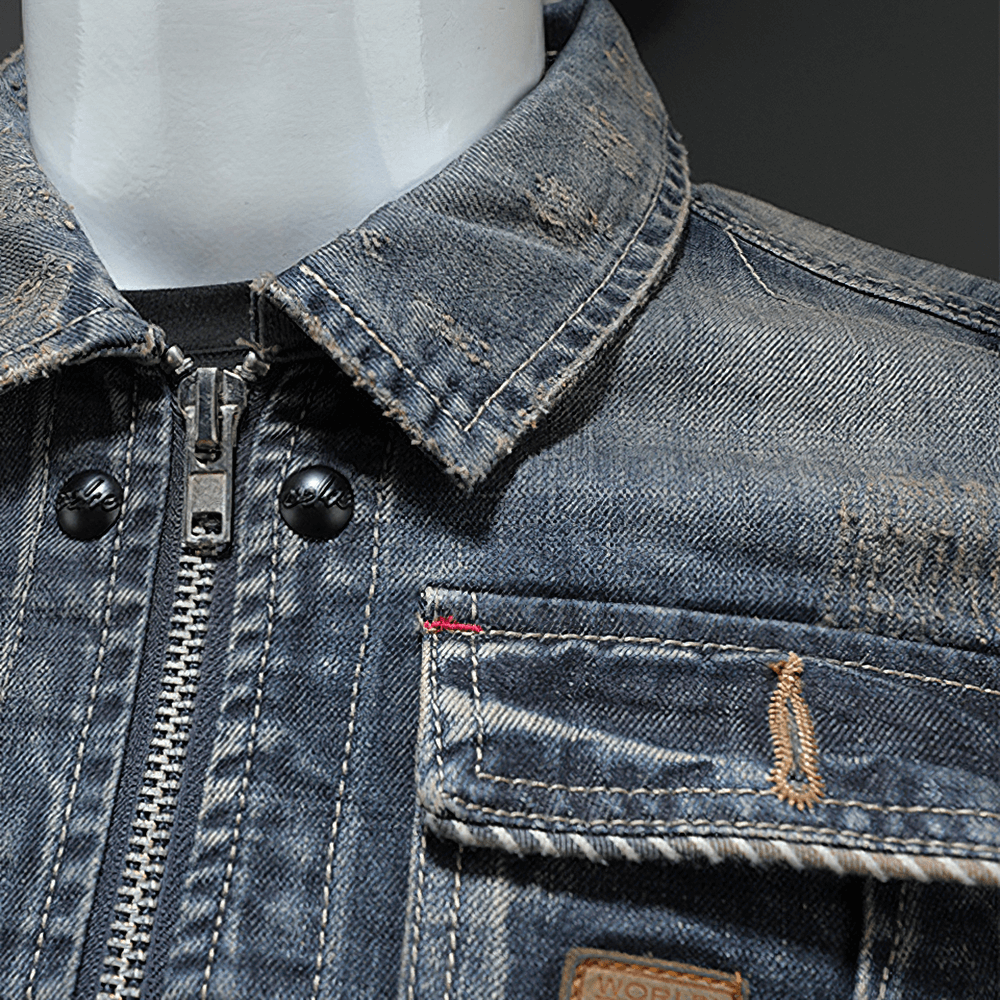 Close-up of a gray men's denim jacket featuring a zipper and classic collar for stylish casual wear.