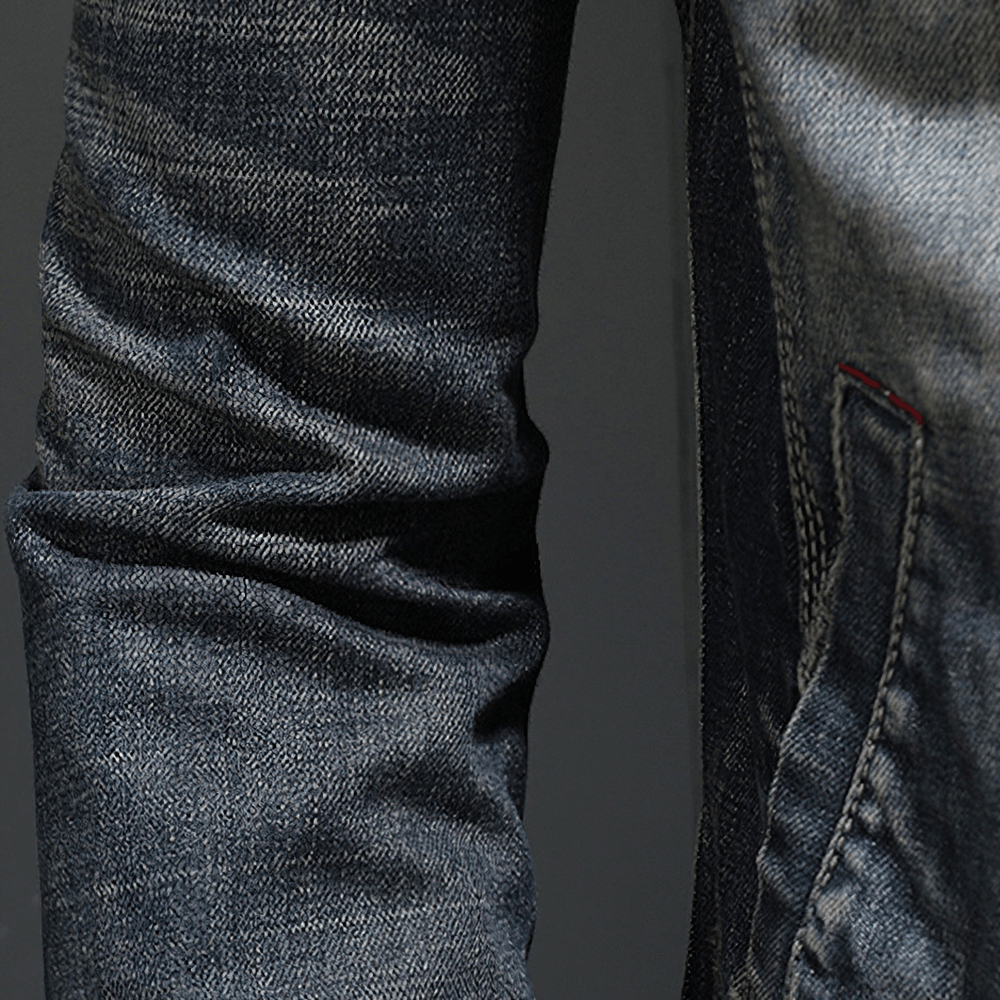 Close-up of a men's gray denim jacket showcasing the stylish fitted cut and detailed fabric texture.