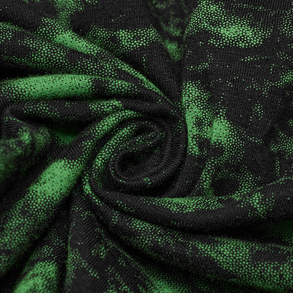 Close-up of black fabric with green speckled pattern, showcasing the unique texture for edgy punk clothing.