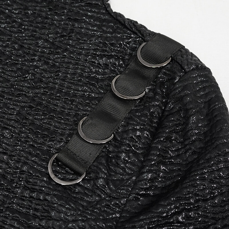 Close-up of a textured black fabric with silver rings and straps, perfect for punk-inspired fashion.
