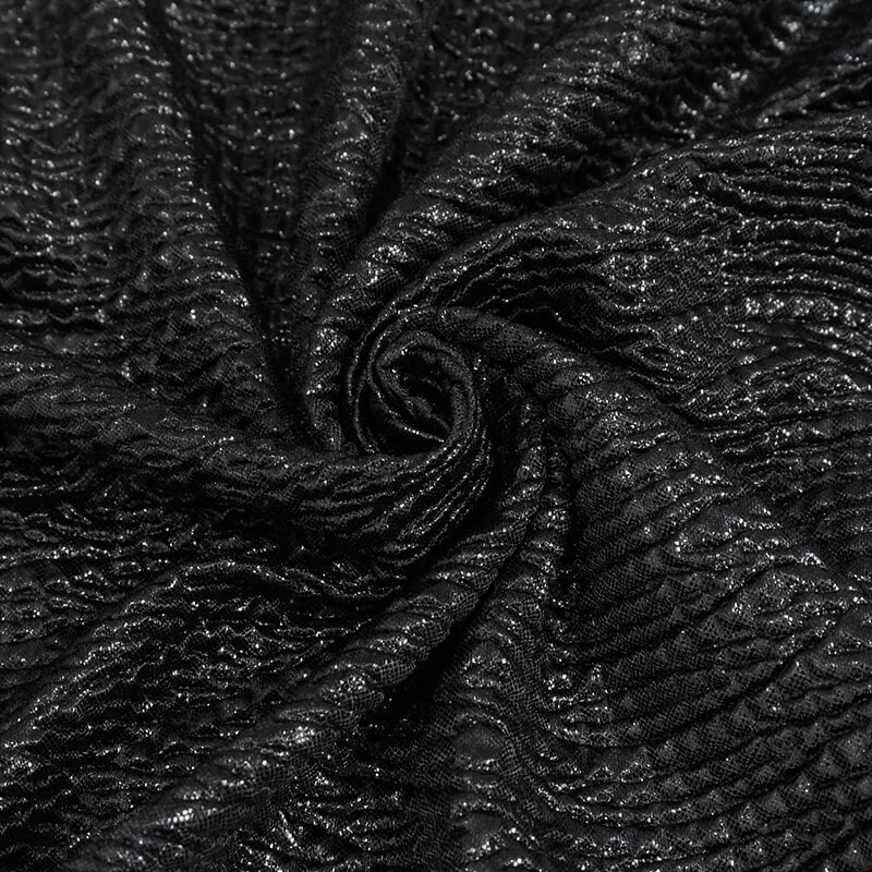 Close-up of stylish black fabric with a textured pattern, perfect for punk fashion tops and trendy outfits.