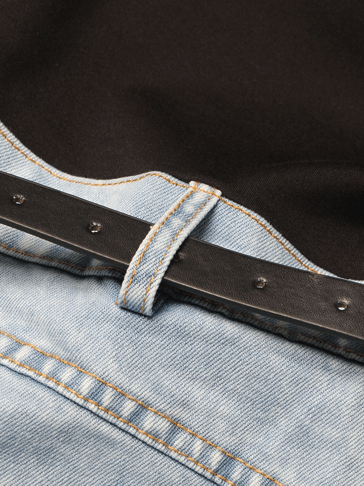 Close-up of high waist denim jeans showing stitching and a stylish belt loop, combining fashion with functionality.
