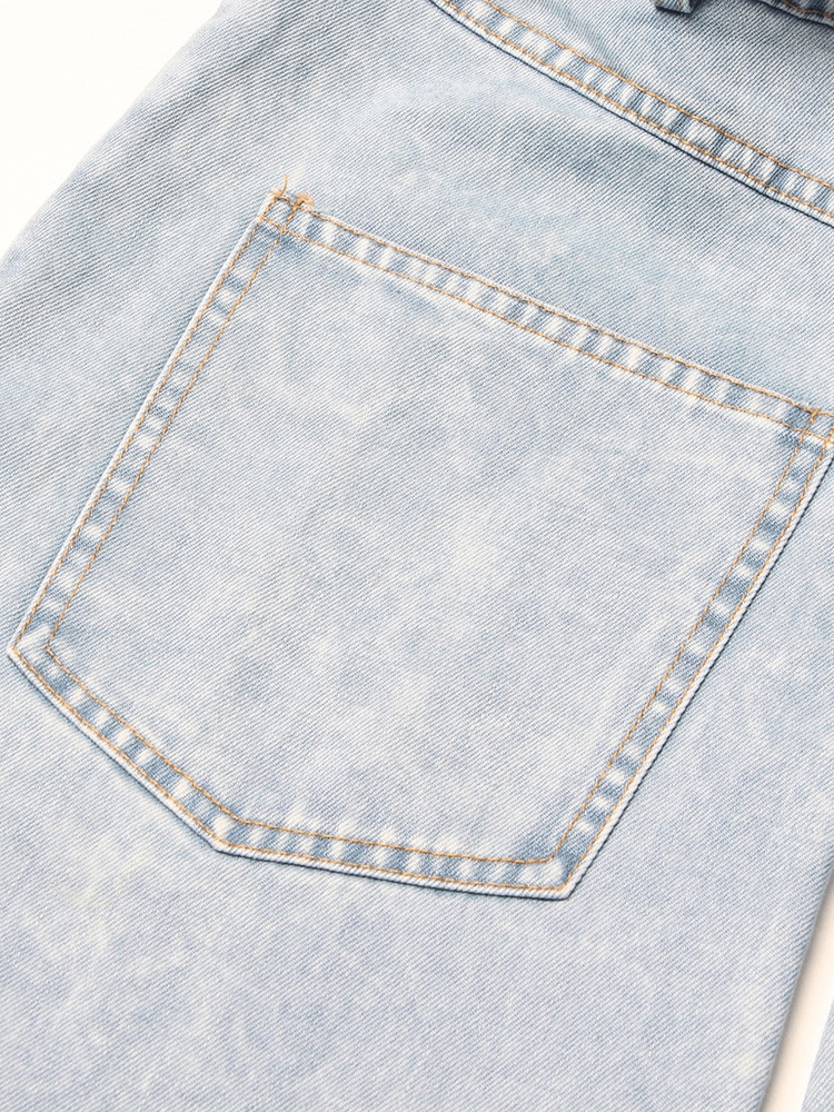 Close-up of the back pocket of high waist light blue denim jeans for women, showcasing stylish details and craftsmanship.