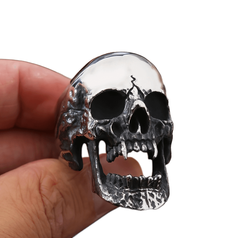 Unisex stainless steel gothic vampire skull ring held in hand, showcasing intricate design and bold style.