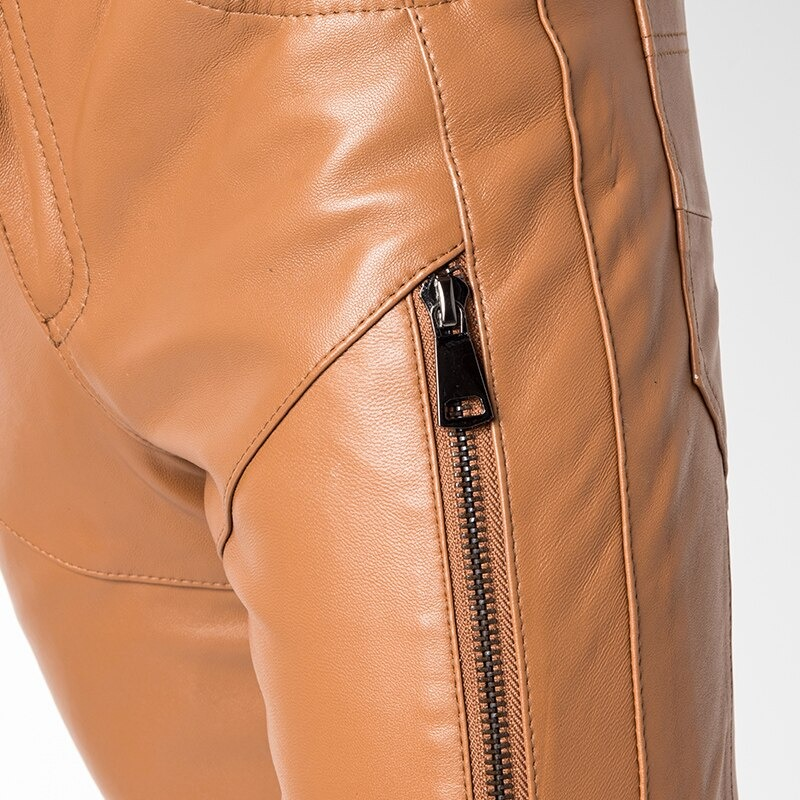 Close-up of trendy men's casual skinny pants featuring a stylish zipper detail in tan leather.
