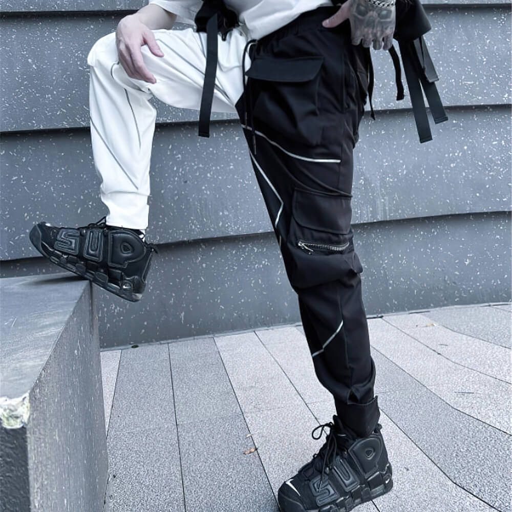 Men's patchwork cargo trousers with pockets, elastic waist, stylish black and white design, perfect for an alternative fashion look.