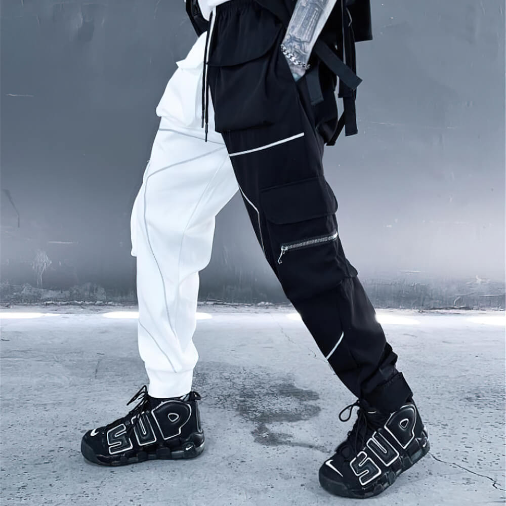 Fashion men's patchwork cargo trousers with pockets, featuring a black and white design and stylish sneakers.