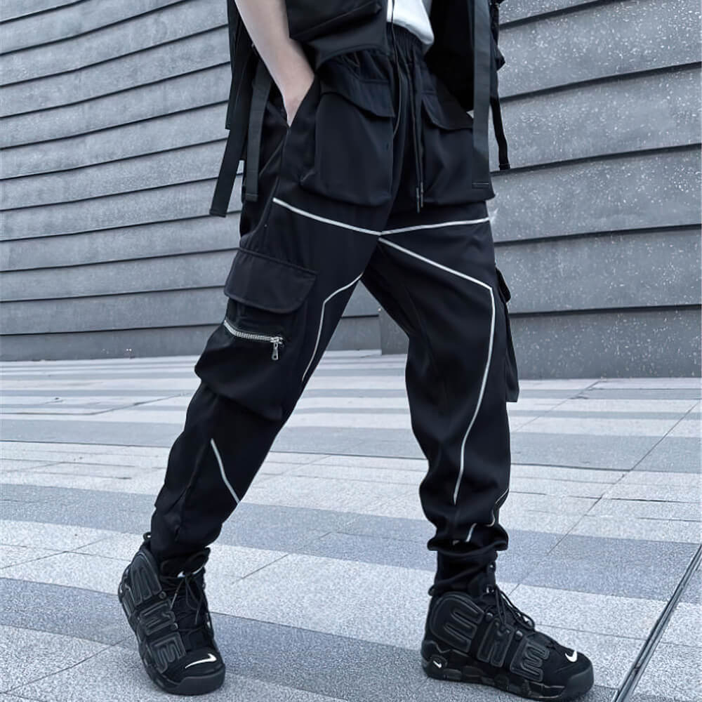 Men's black patchwork cargo trousers with pockets, designed for an edgy alternative style and a comfortable elastic waist.