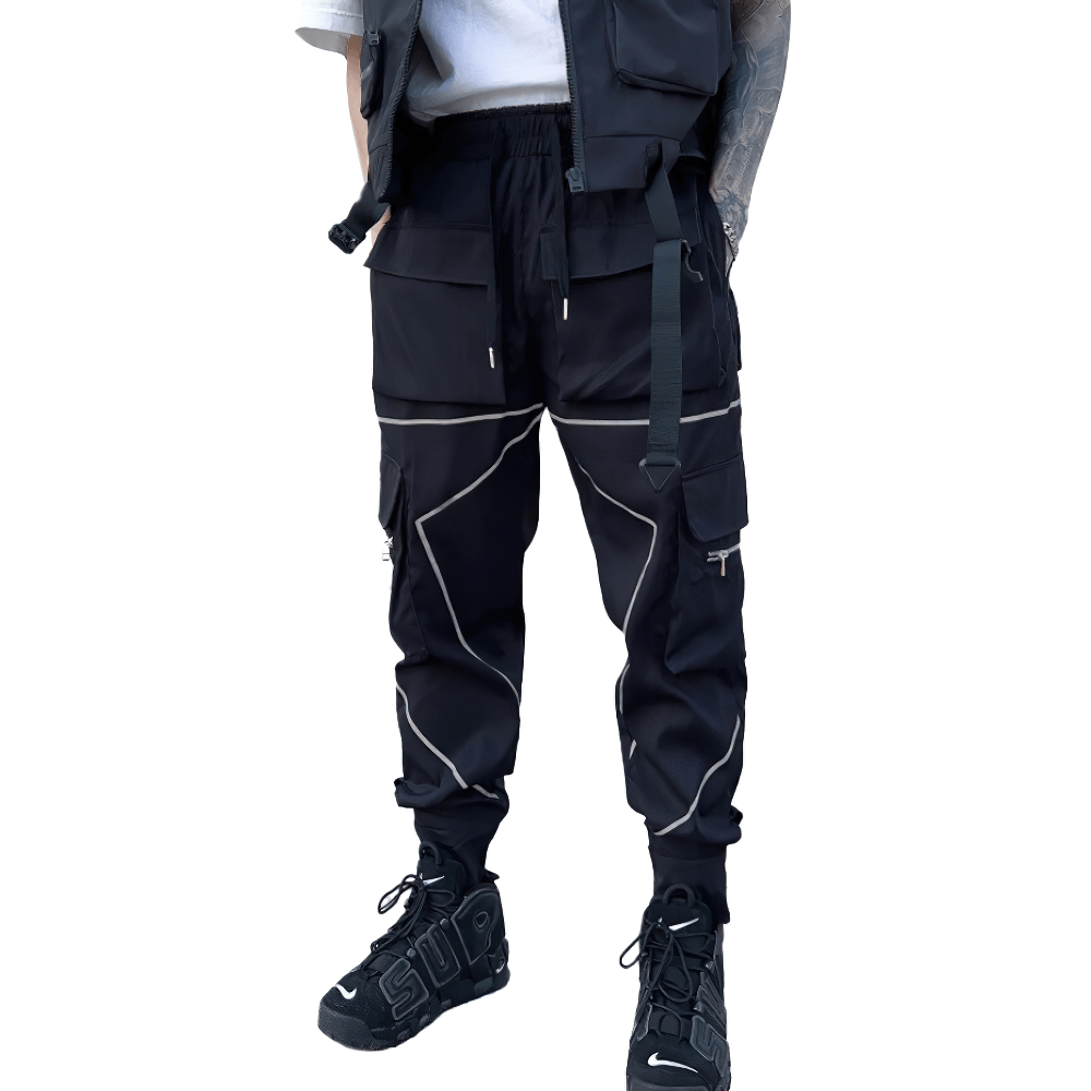 Men's black patchwork cargo pants with pockets and elastic waist, perfect for a trendy alternative style.