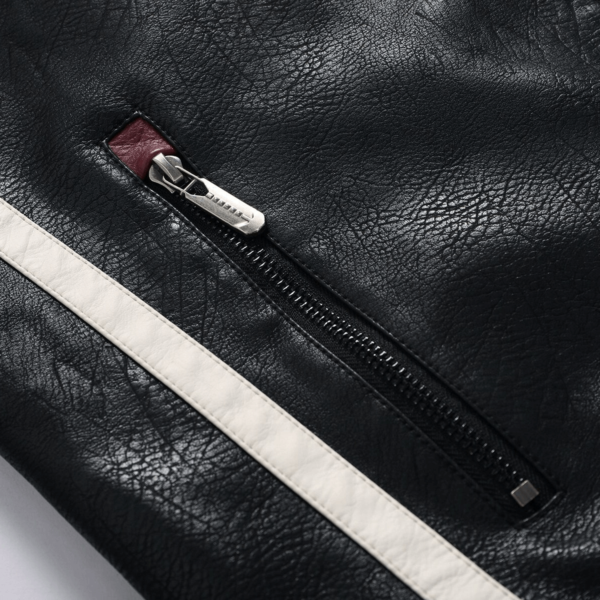 Close-up of the zipper detail on a black PU leather men's motorcycle jacket with white stripes.