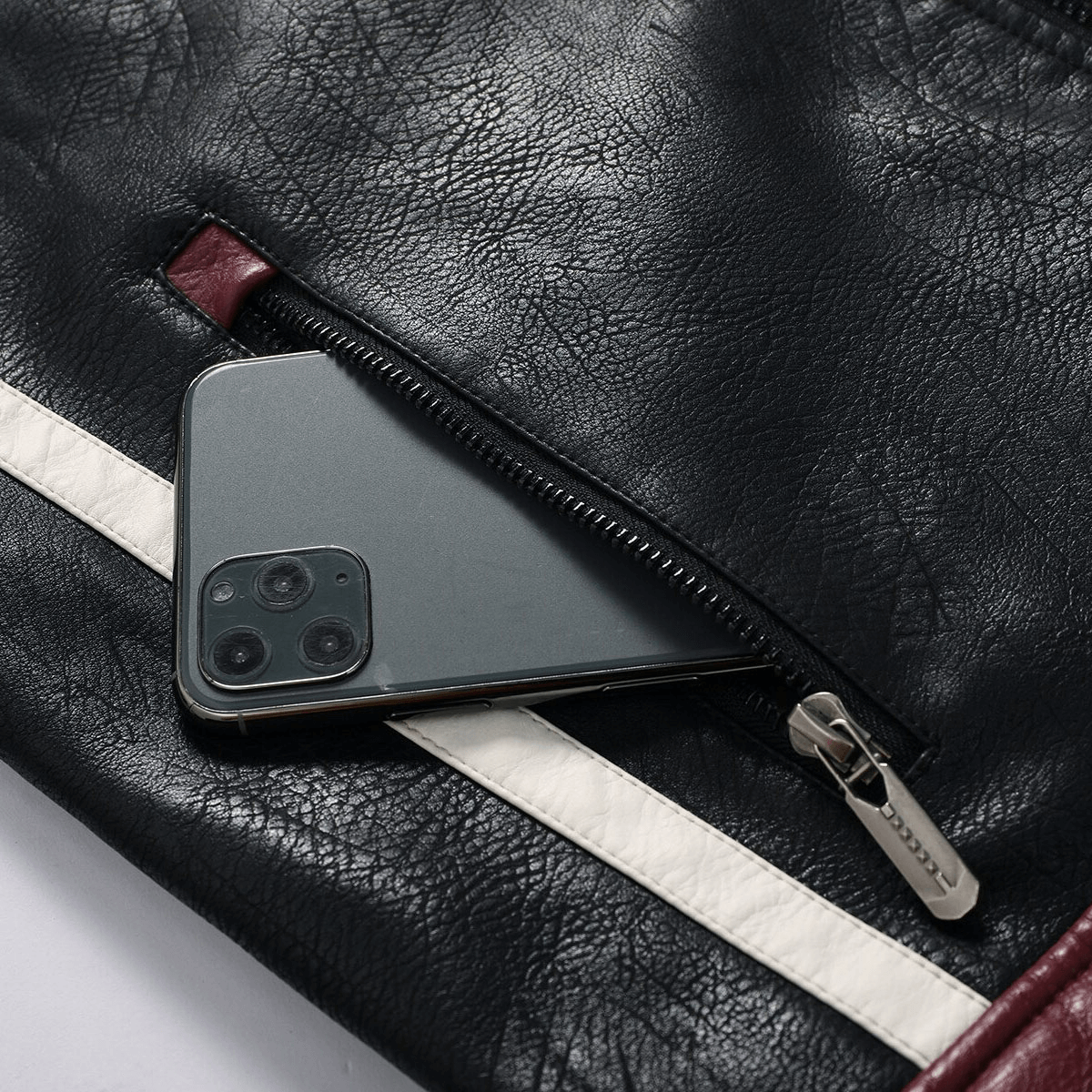 Close-up of a stylish men's zipper PU jacket pocket with a smartphone inside, showcasing casual biker clothing.