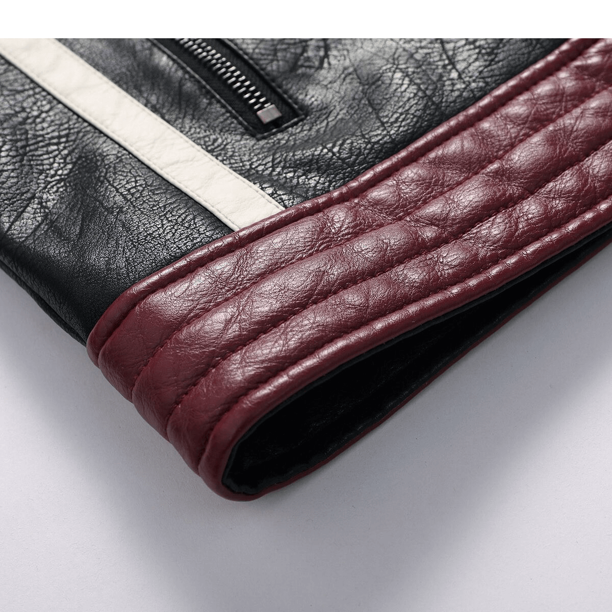 Close-up of the edgy black PU leather jacket sleeve featuring stylish burgundy quilted detail.