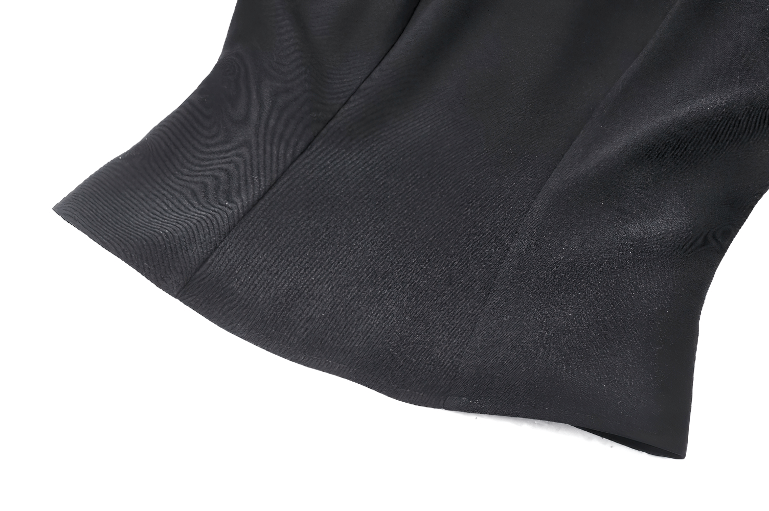 Close-up of the sleek hemline on a trendy black high-collar women's jacket with mesh panels.