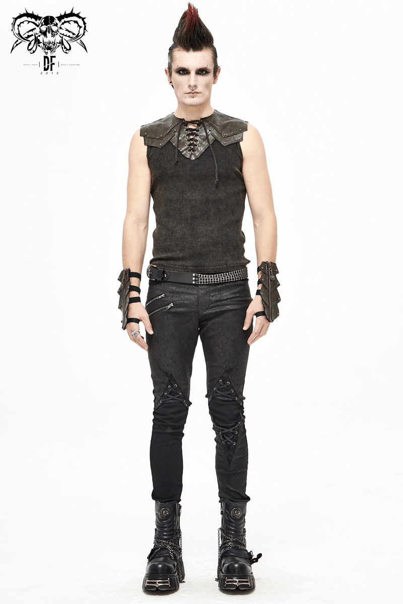 Stylish goth-inspired man wearing sleeveless top, leather collar, and edgy accessories, showcasing alternative fashion.