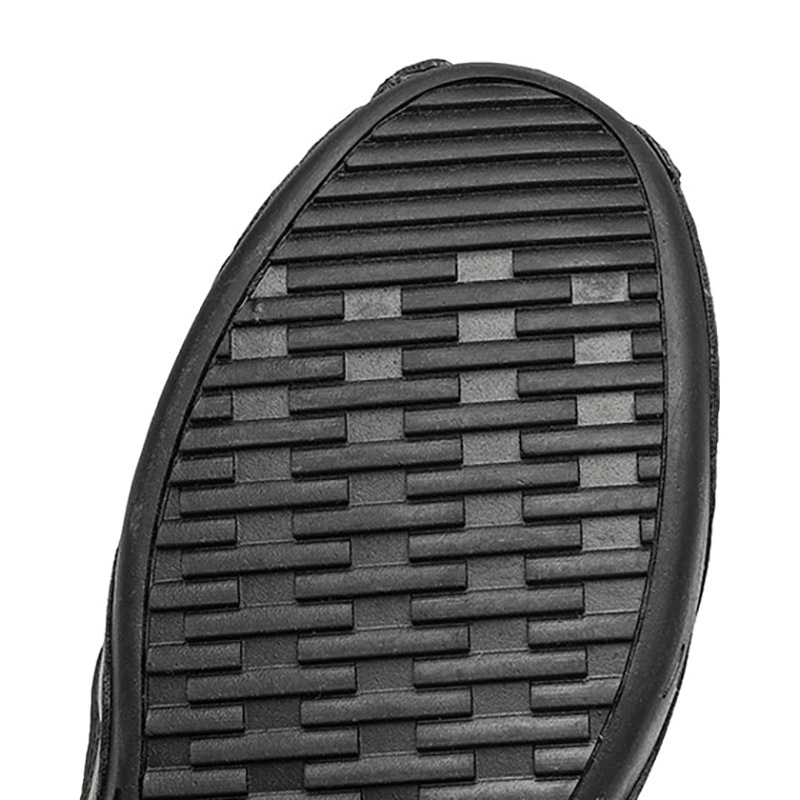 Close-up of non-slip sole of men's leather sandals, showcasing durable grip and practical design for outdoor activities.