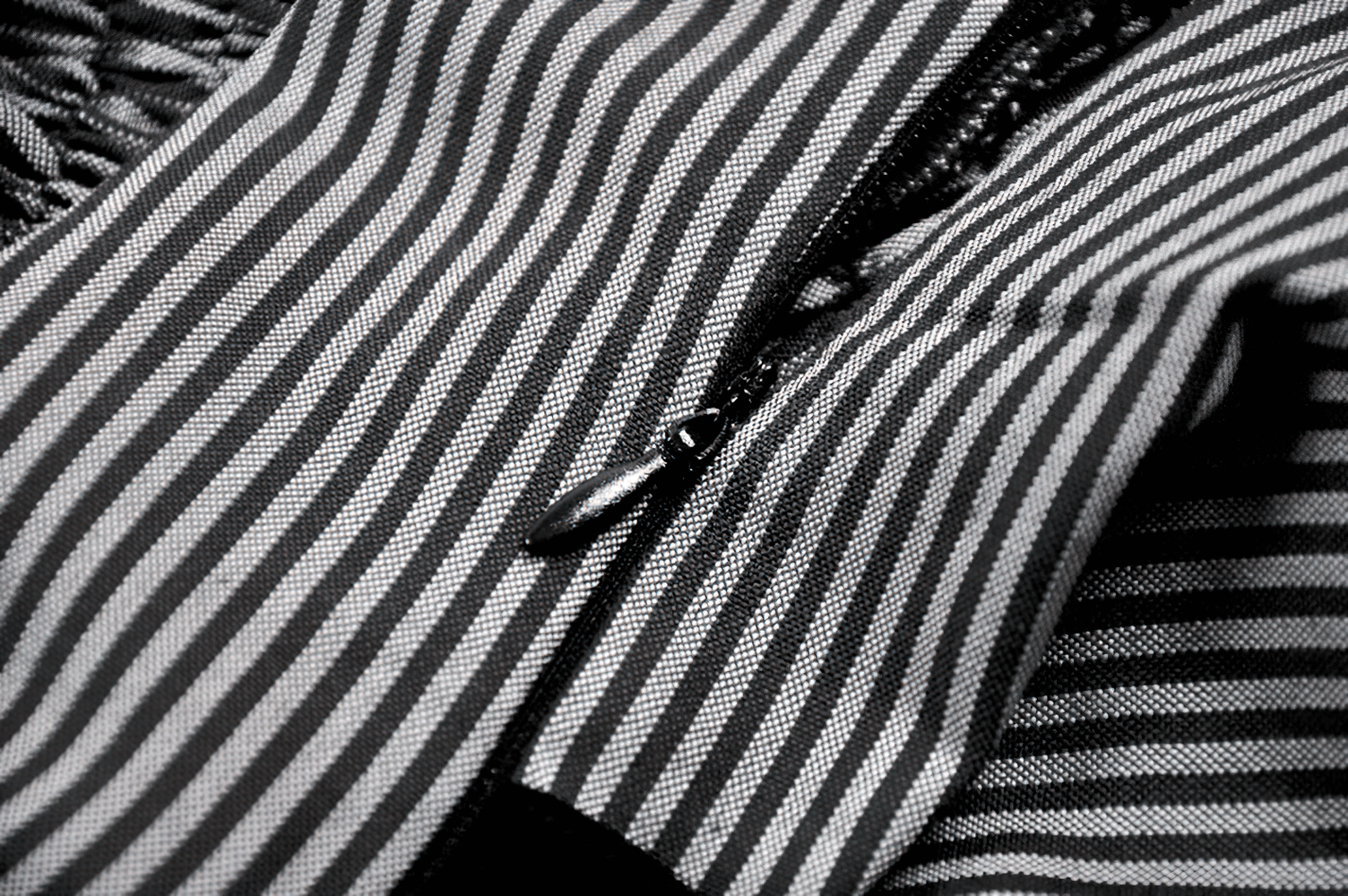 Fashion Pinstripe Ruffle Dress with Lace Hem and Belt close-up showing pinstripe fabric and zipper detail.