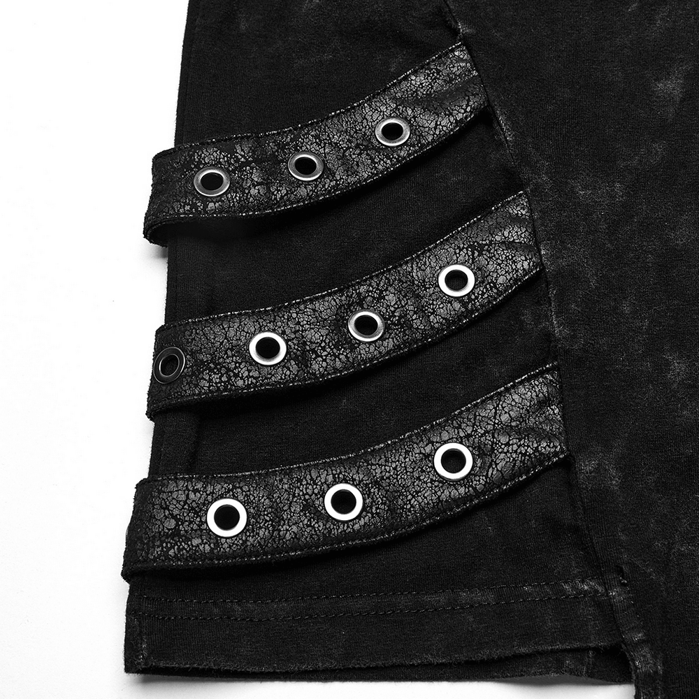 Detail of distressed punk vest with eyelet ribbons and layered design for a bold, edgy look.