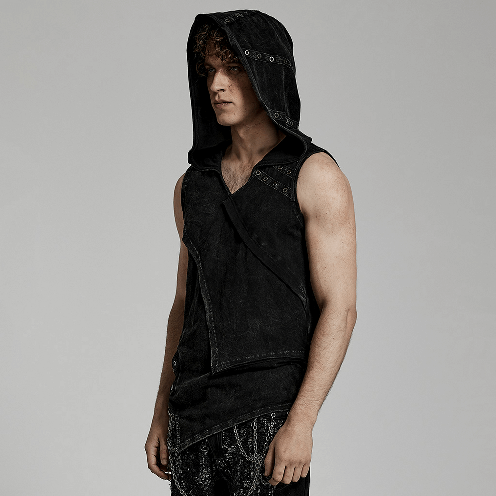 Model wearing a distressed black hooded vest with eyelets, showcasing punk style and edgy fashion.