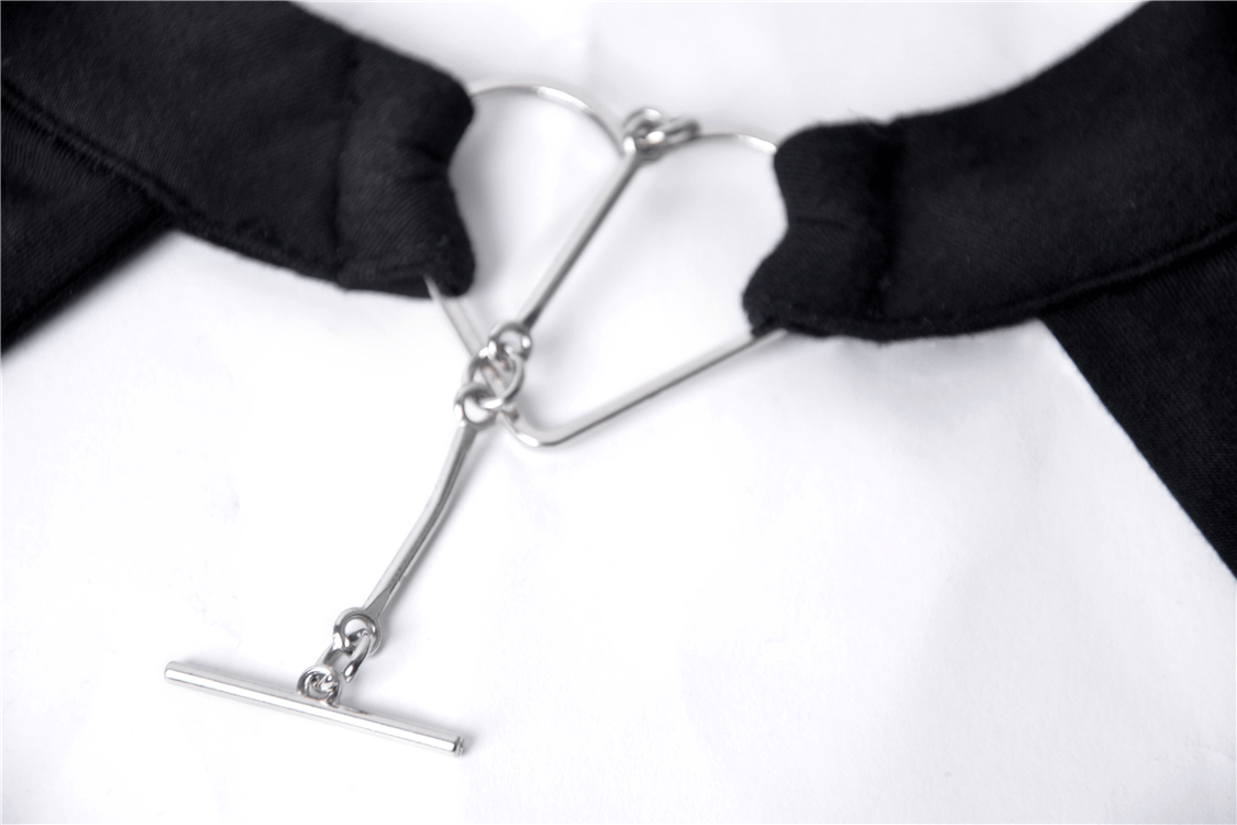 Close-up of the heart-shaped metal detail on the choker of a punk-style women's top.