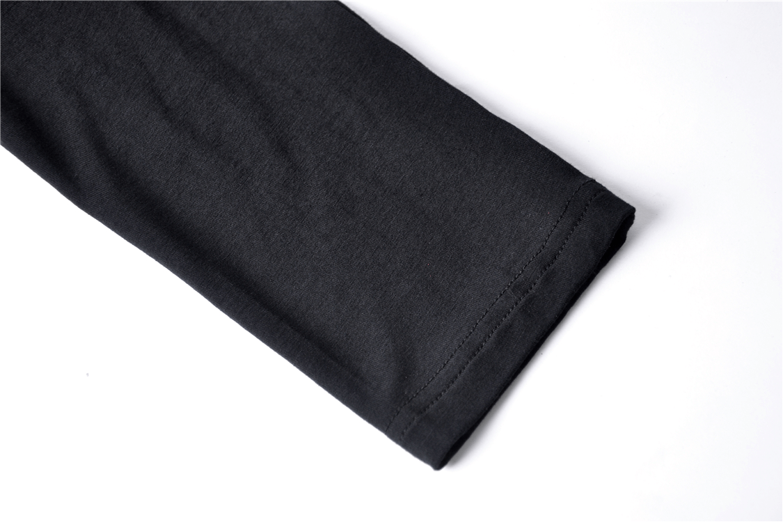 Close-up of the sleeve of a black off-shoulder choker top showcasing soft and stretchy knit fabric.