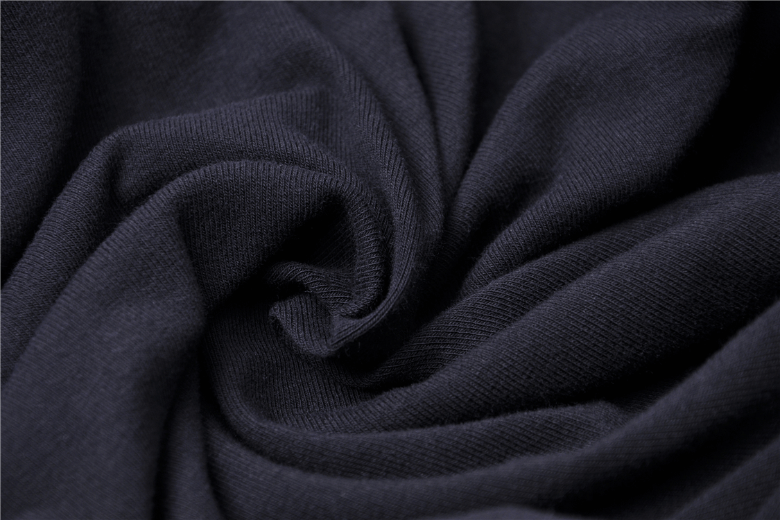 Close-up of soft and stretchy black knit fabric, perfect for edgy fashion tops.