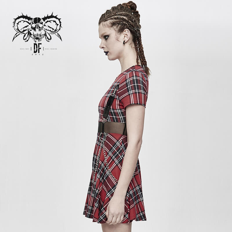 Side view of a woman in a red plaid mini dress with a belt, showcasing punk style and edgy fashion.