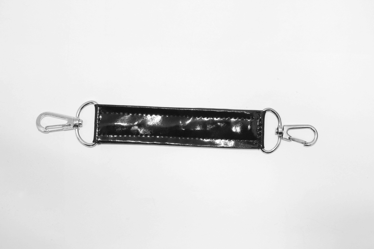 Black glossy strap with silver clips, perfect accessory for punk style outfits or bags.