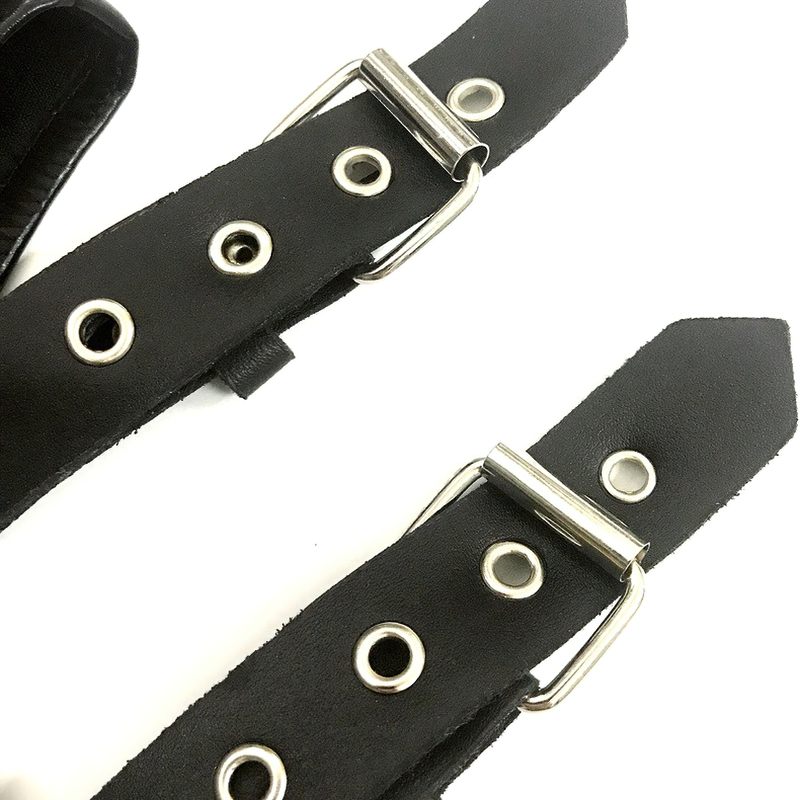 Close-up of stylish black PU leather straps with metal buckles and eyelets, perfect for fashion-forward outfits.