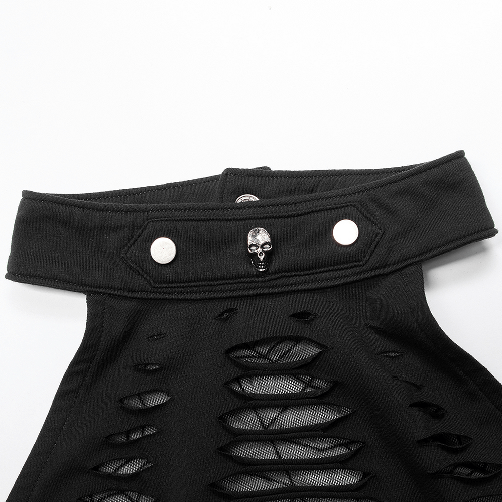 Close-up of stylish black halter top with skull button and mesh cutouts, perfect for edgy fashion lovers.