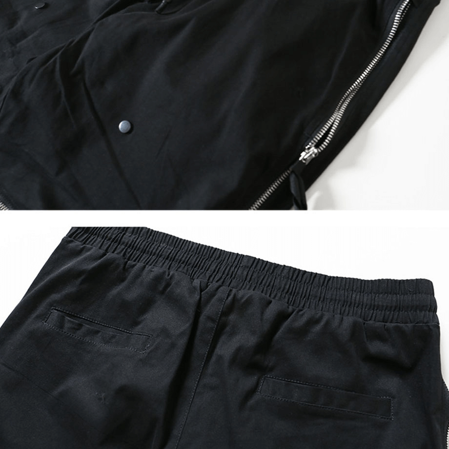 Close-up of black tactical zipper trousers showcasing elastic waist and functional zipper details.