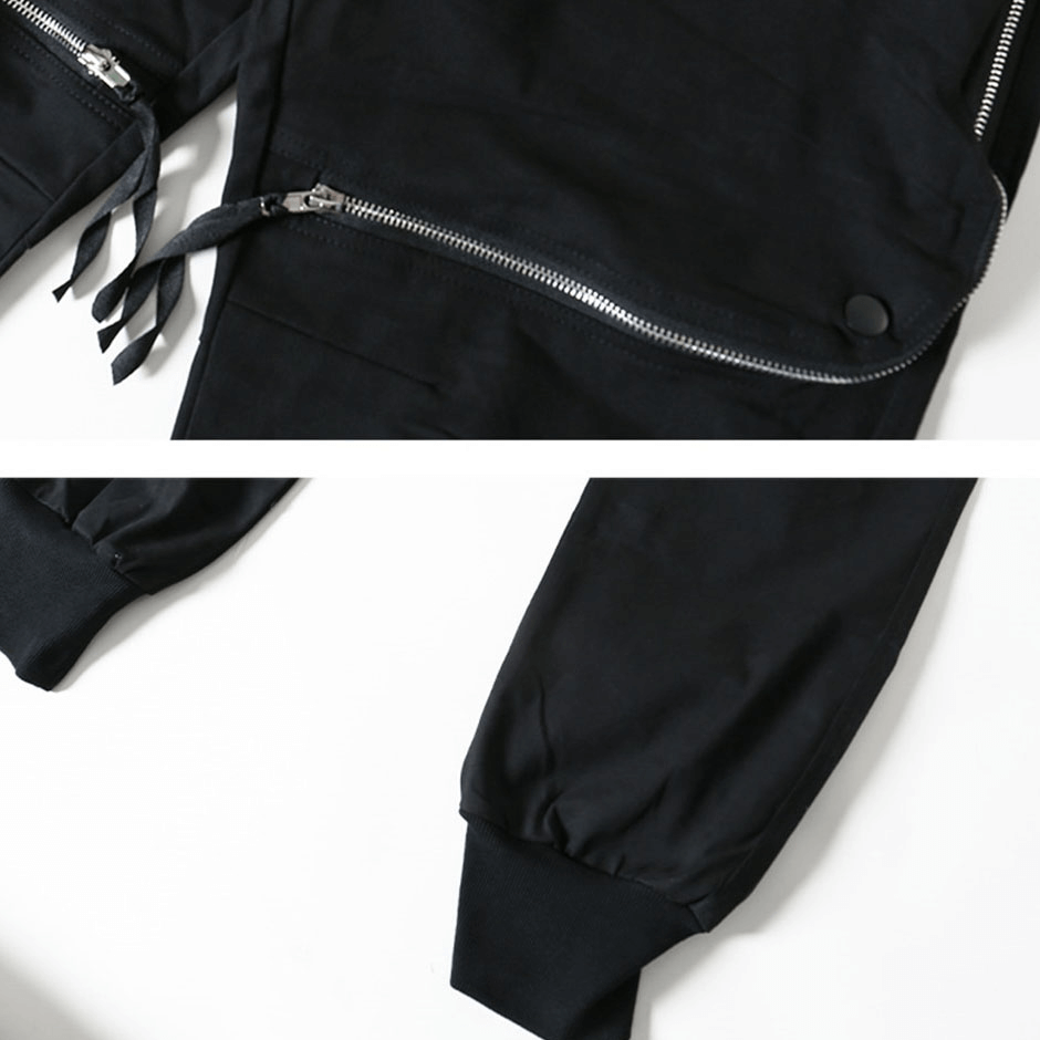 Close-up of black tactical zipper trousers detailing elastic waist and zippers, showcasing trendy functional design.