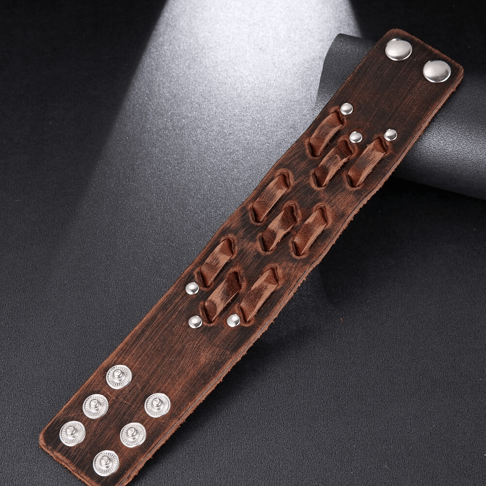 Wide genuine leather bracelet showcasing vintage punk style with silver studs on a dark background.