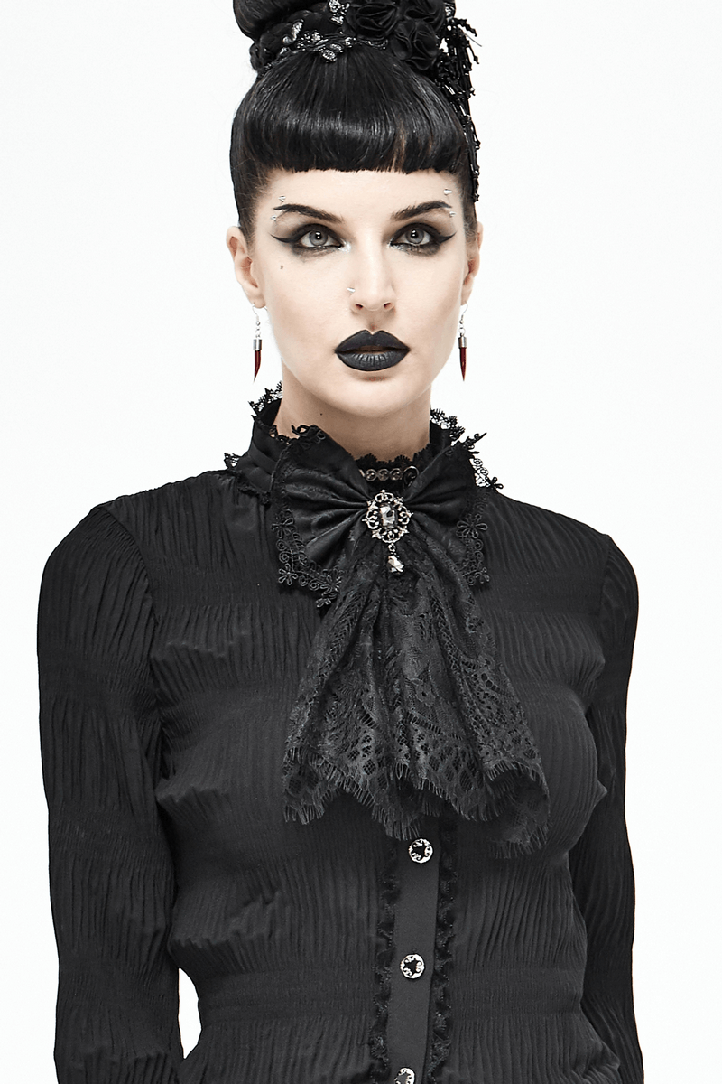 Fashionable woman in gothic style wearing a black lace bow tie with silver brooch, exuding elegance and vintage charm.