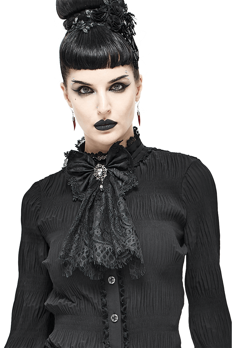 Fashionable woman in black lace bow tie, showcasing gothic vintage style with striking makeup and elegant accessories.