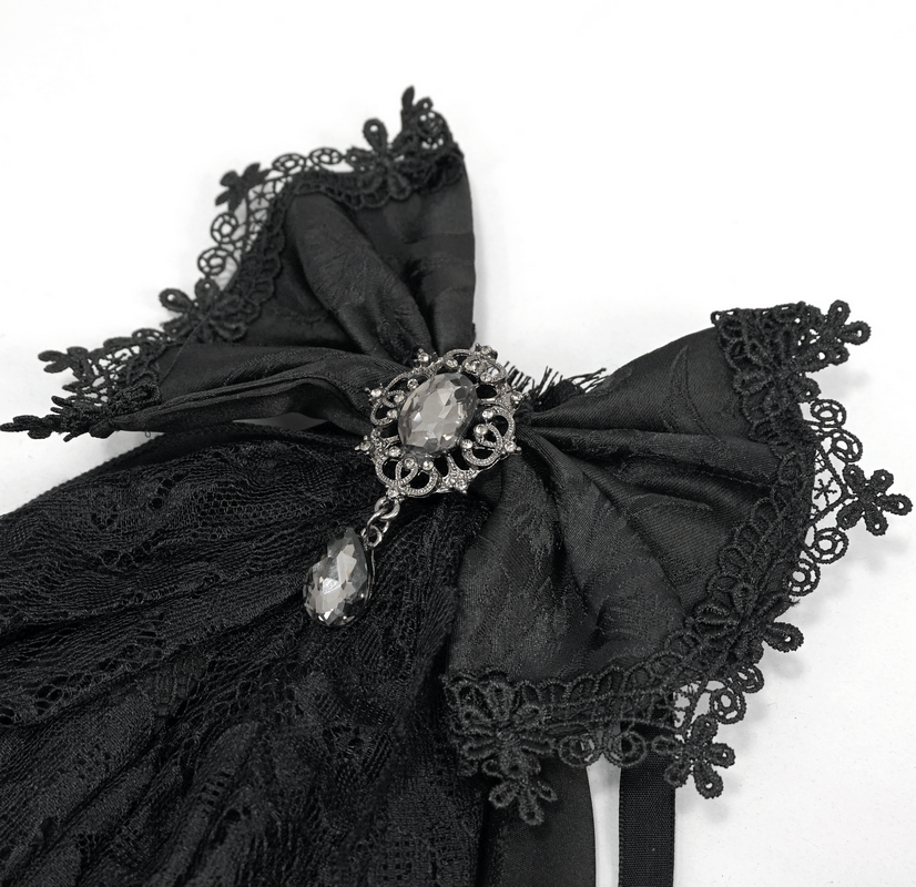 Vintage women's black lace bow tie with silver brooch, perfect for gothic steampunk outfits.
