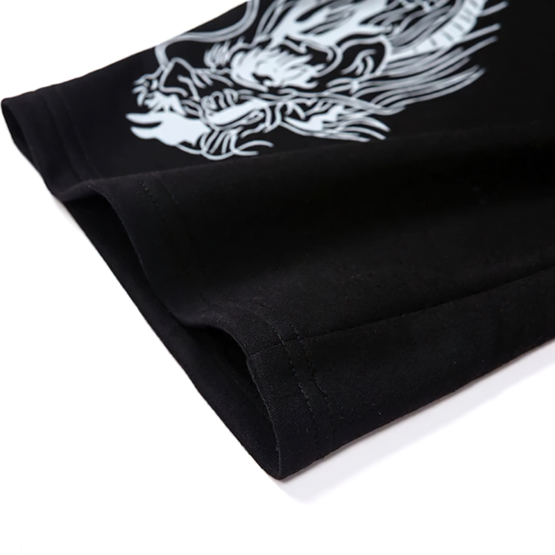 Close-up of the sleeve of a black women's loose pullover featuring a dragon print, showcasing quality fabric and stylish design.