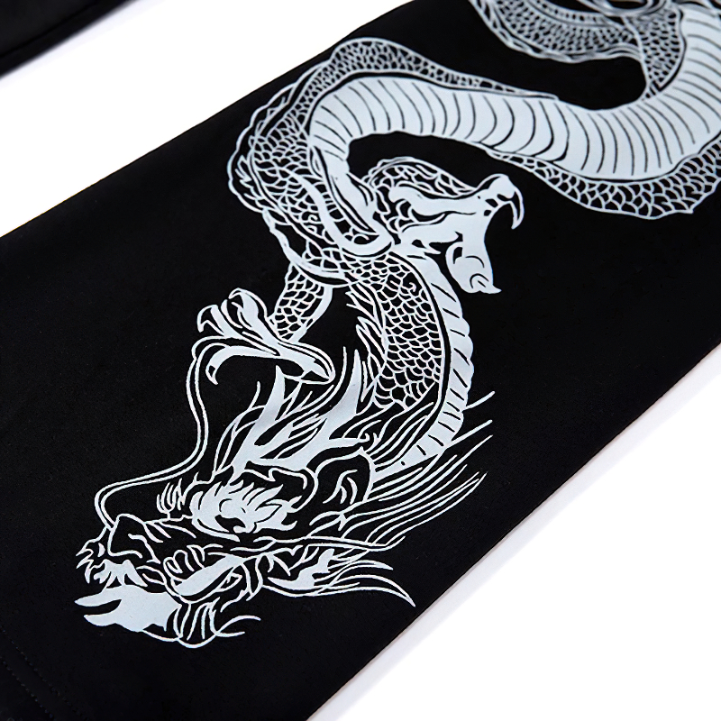 Close-up of a dragon print on a black pullover sleeve, showcasing intricate detailing and stylish flair.