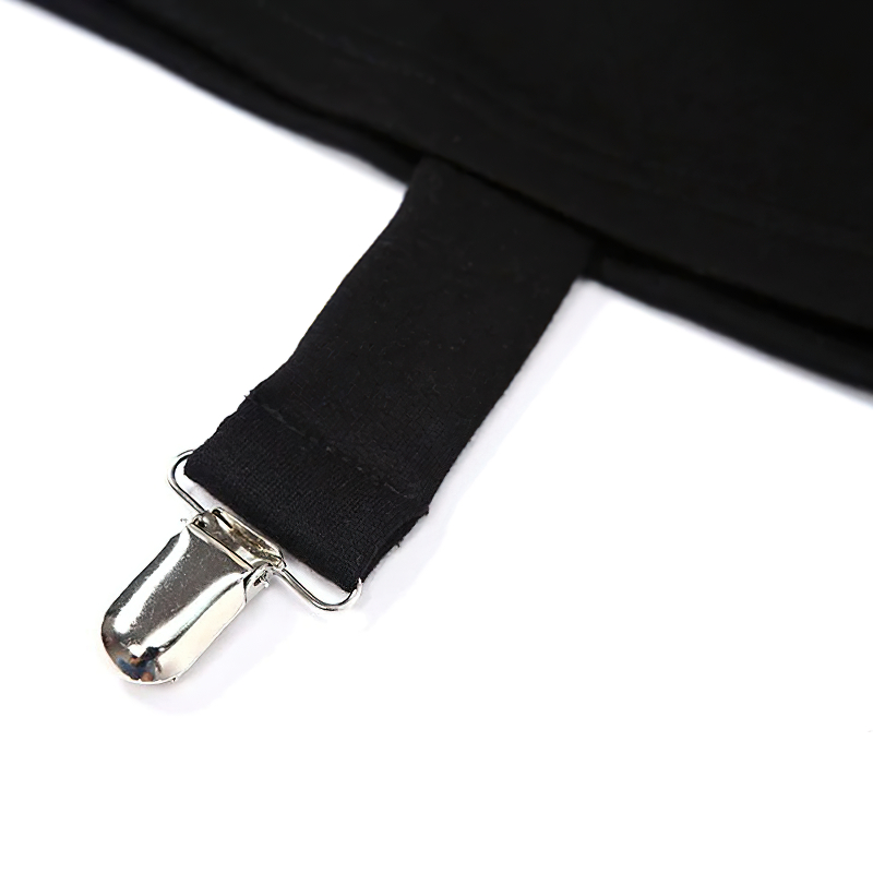 Close-up of a black top's strap with a silver clip, showcasing stylish and functional design details.