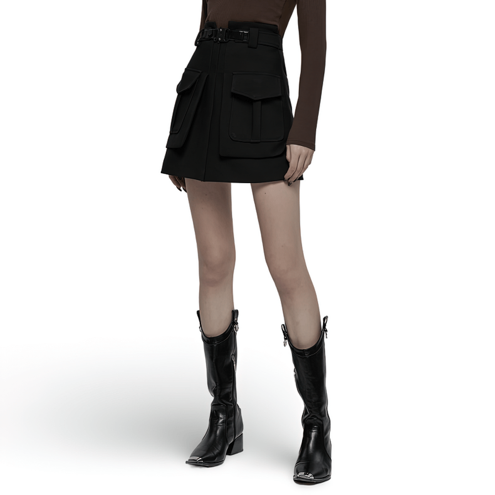 Trendy black A-line skirt with buckle and pockets, styled for a chic high-waist look paired with stylish boots.