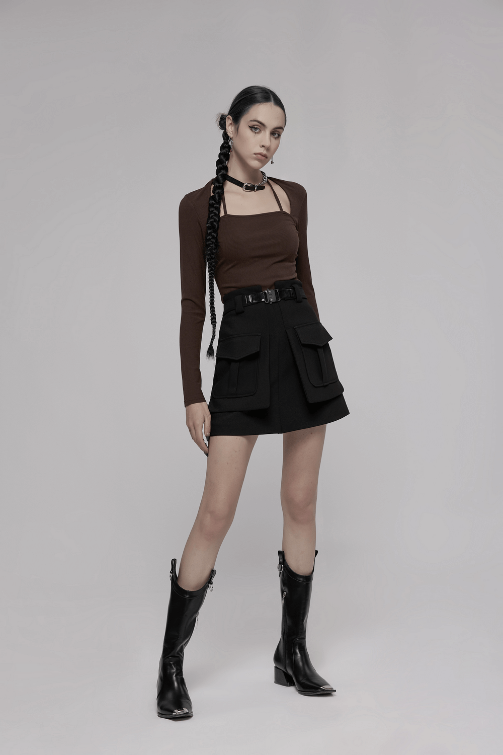 Fashionable high-waist A-line skirt with buckle, paired with stylish top and boots, perfect for trendy outfits.