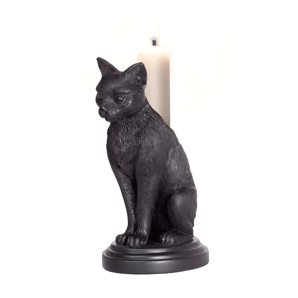 Black cat candlestick holder with a candle, perfect for witchy home decor and altar setup.