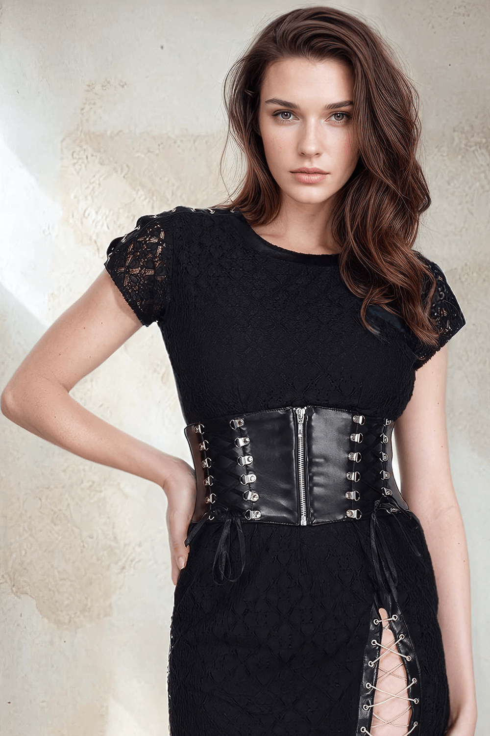 Model wearing a black dress with a faux leather Bessy corset belt, showcasing posture support and stylish design.