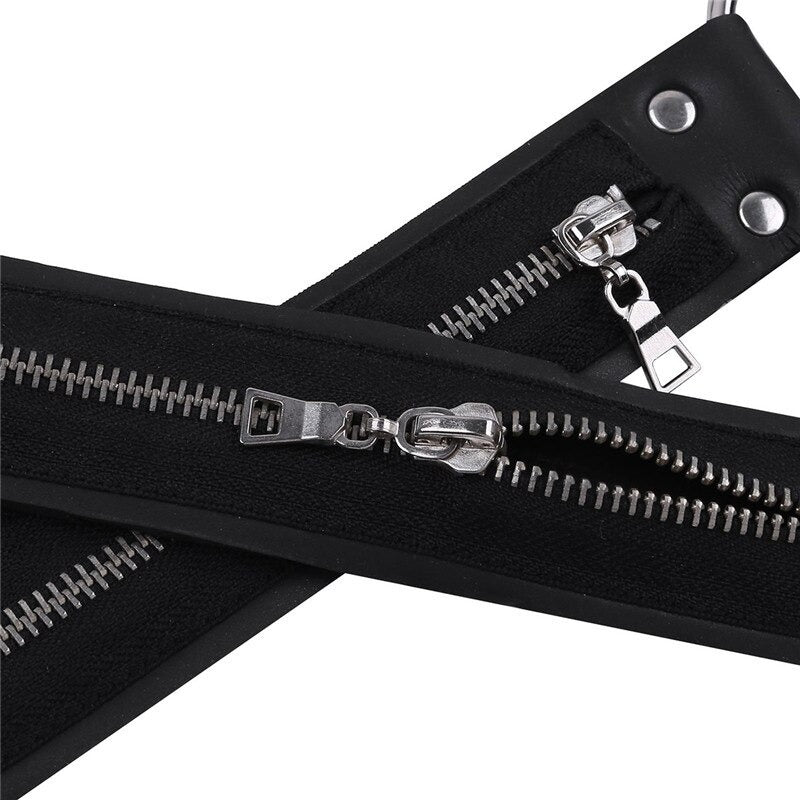 Close-up of black faux leather shoulder harness featuring stylish metal zippers and decorative elements.