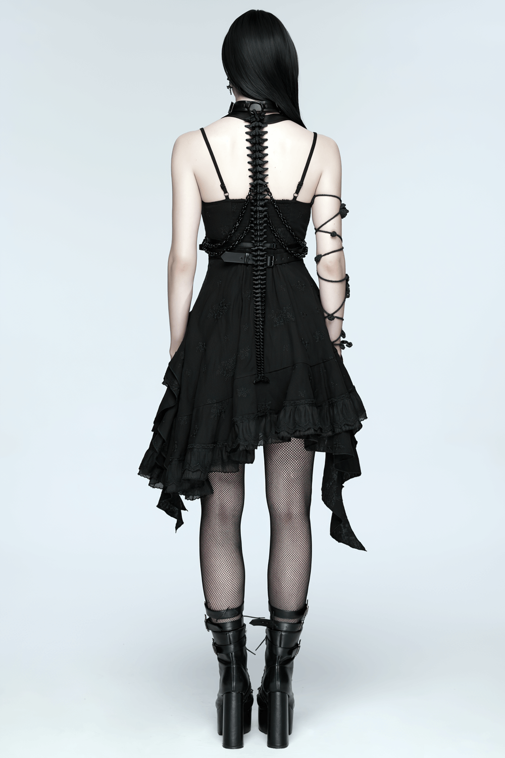 Faux Leather Cyberpunk Skeleton Harness with Chains worn with a stylish black dress showcasing a punk aesthetic.