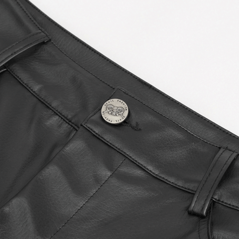 Close-up of black faux leather fitted pants waistband with logo button detail, showcasing edgy design elements.
