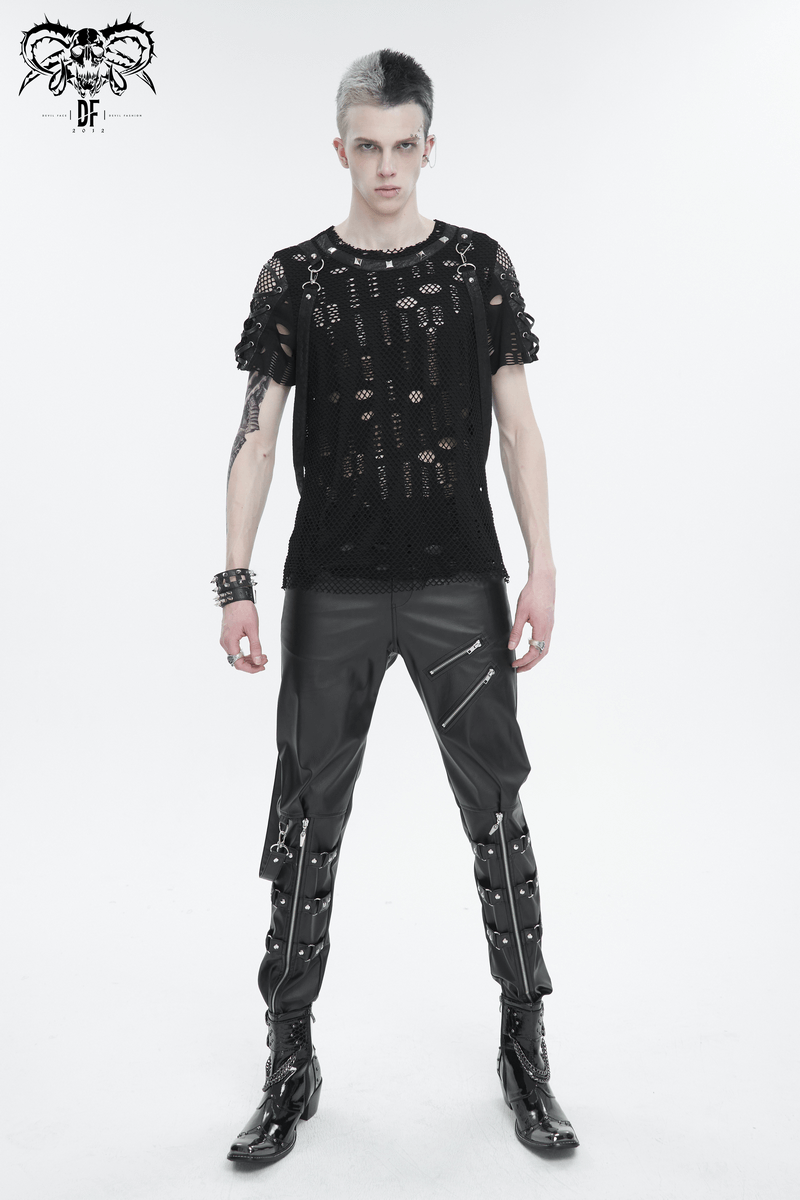 Punk-inspired male model showcasing black faux leather fitted pants with detachable straps and an edgy sheer top.