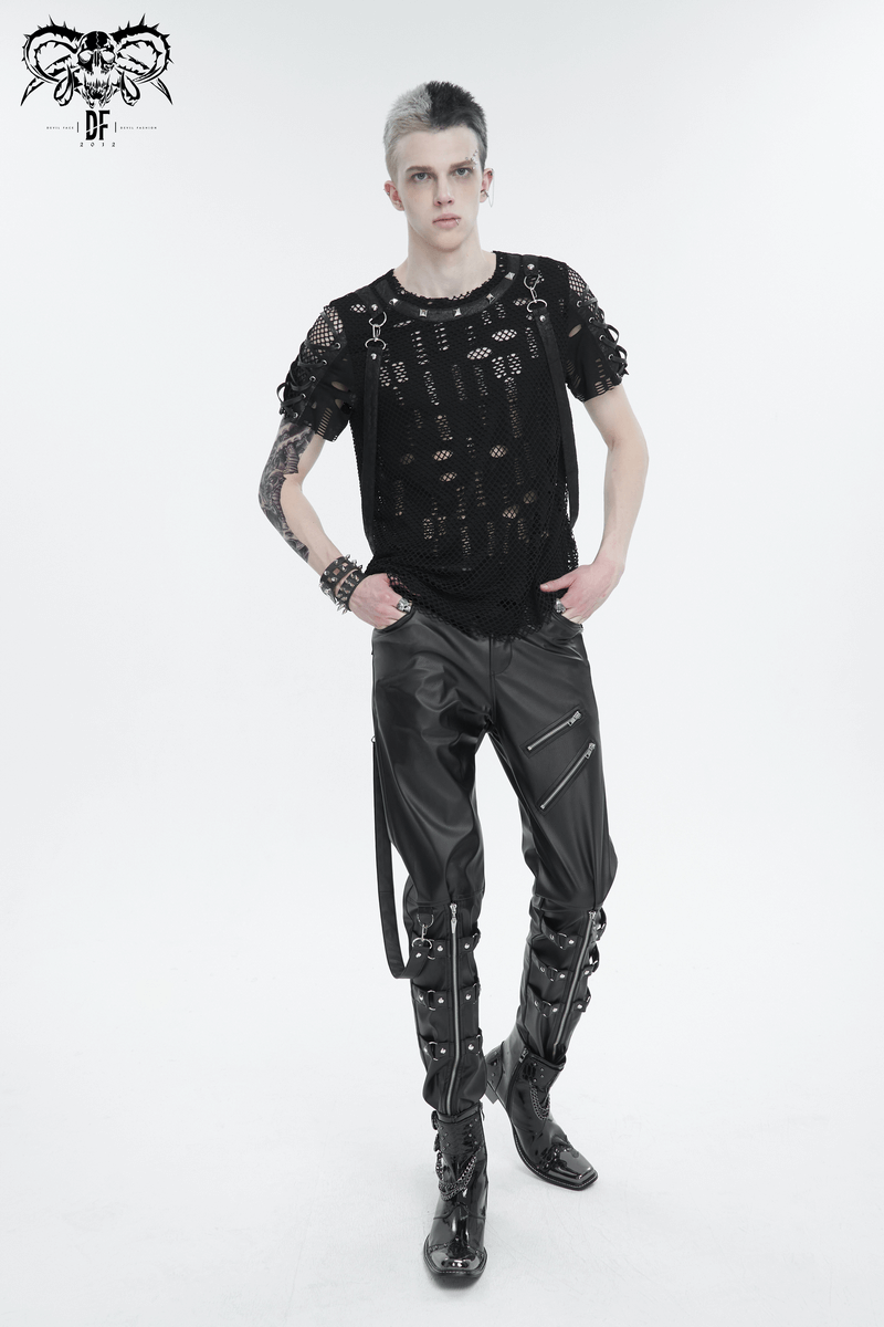 Punk-inspired male model in black faux leather fitted pants with detachable straps and edgy accessories.