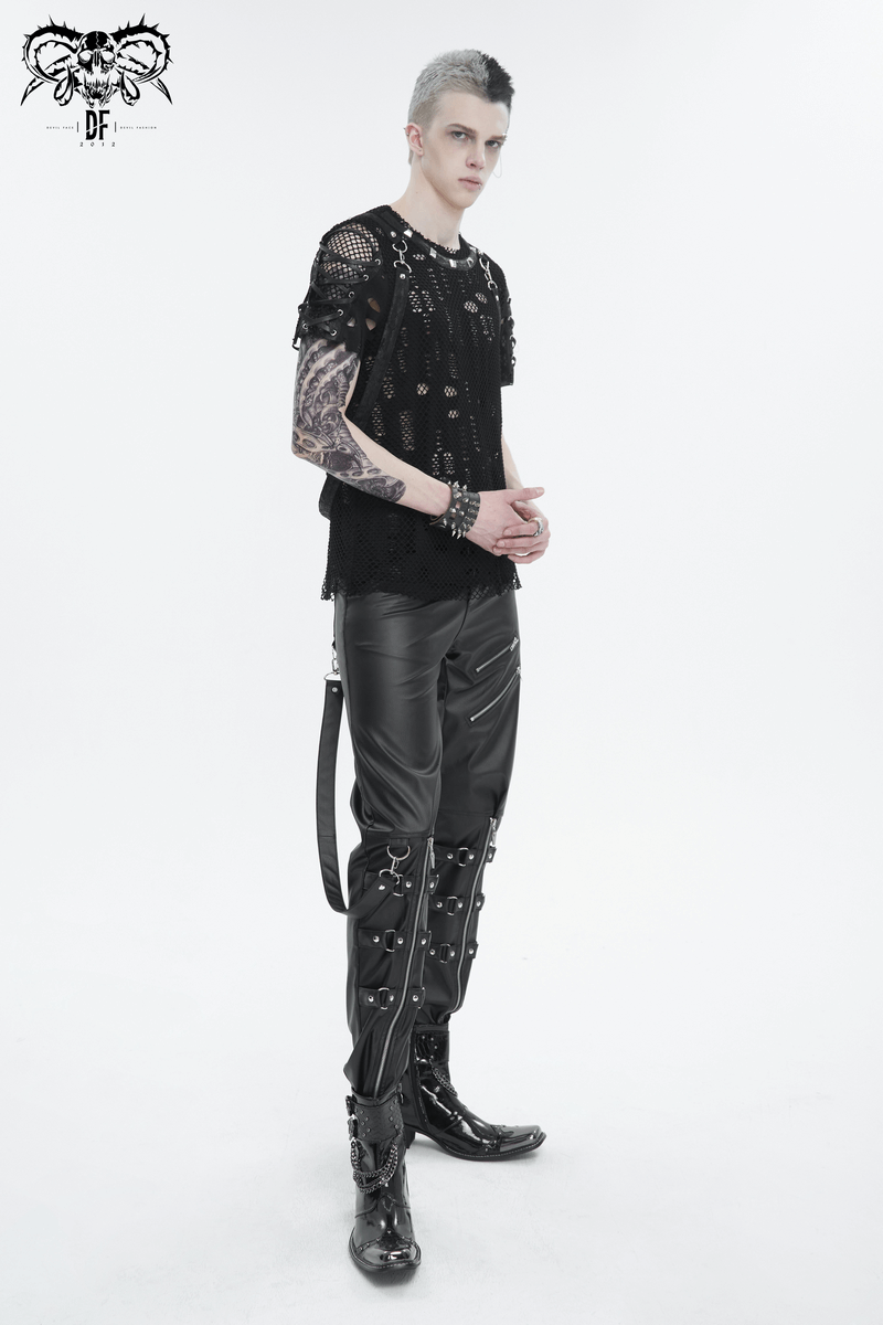 Edgy male model showcasing punk-inspired faux leather pants with detachable straps and a stylish black mesh top.